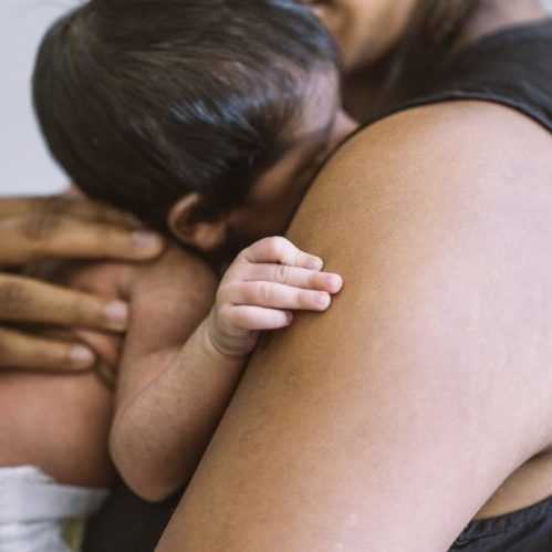 Mom holding newborn baby close