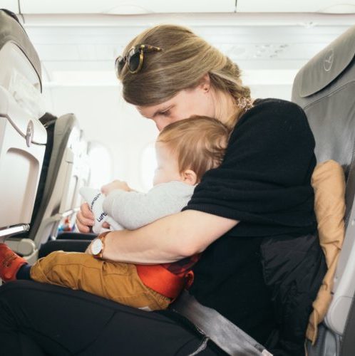Mom and baby seated on an airplane